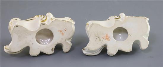 A pair of Derby porcelain figures of recumbent poodles, c.1825-45, L. 10.5cm, one restored